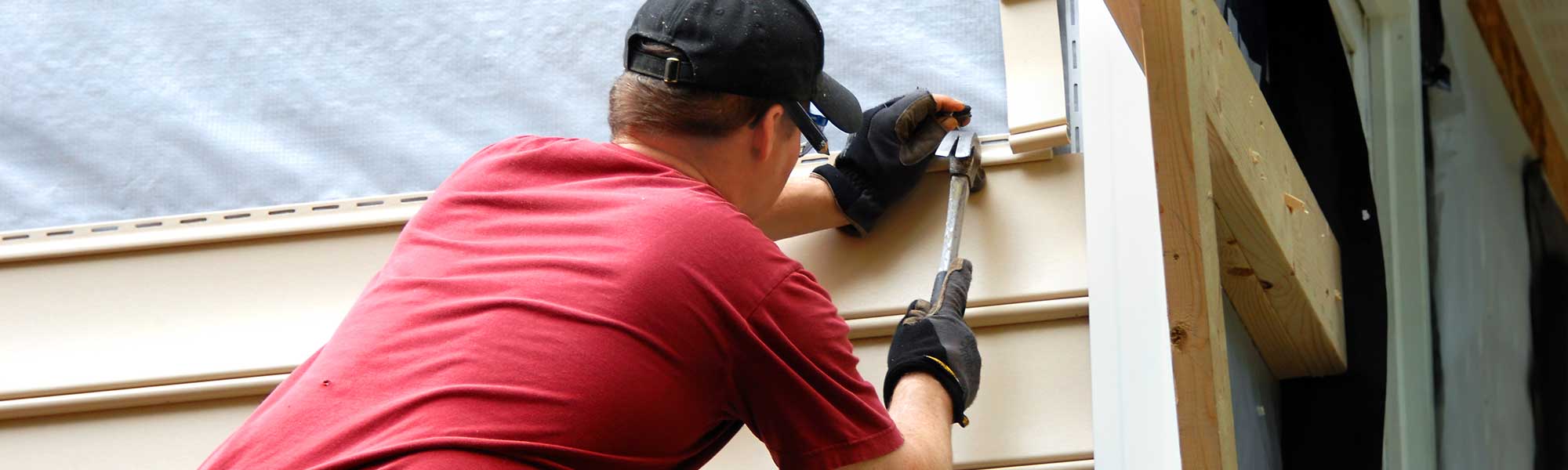 Worker Finishing Siding